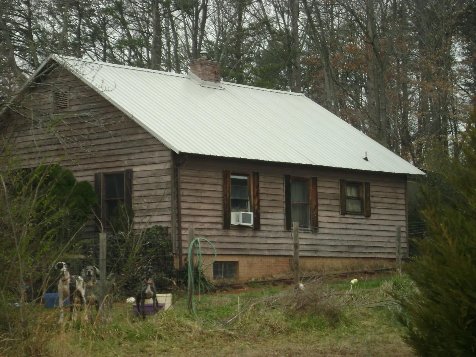 White metal roof on an old wood sided farmhouse, from a Asphalt Shingle Roof Repair job in Eure
